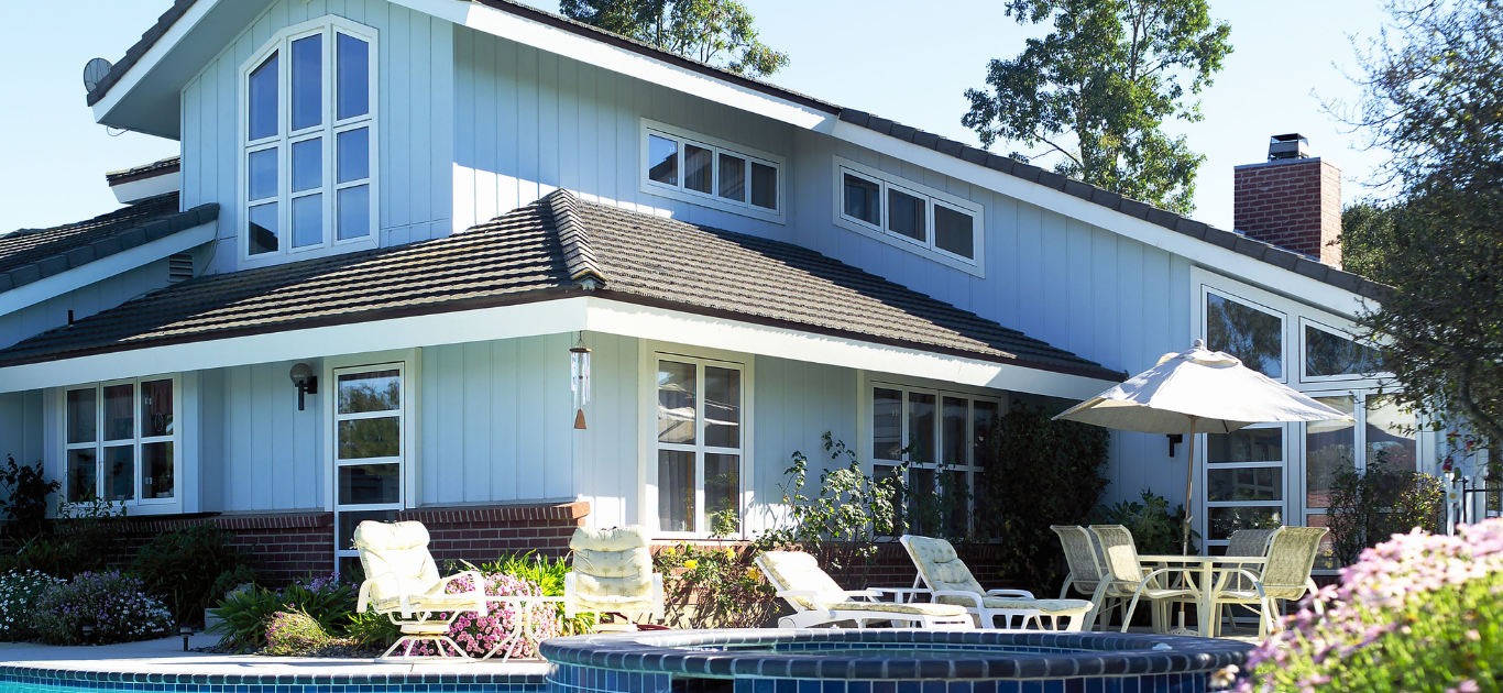 House displaying areas to be inspected during the home inspection, such as roof, windows, siding, and swimming pool.