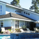 House displaying areas to be inspected during the home inspection, such as roof, windows, siding, and swimming pool.